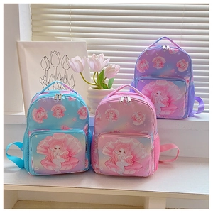 Three cute mermaid print backpacks for girls in blue pink and purple on a sunny window