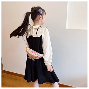 Girl wearing a pink and yellow sequined fish tail fanny pack in a minimalist home setting
