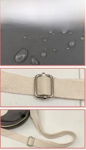 Detail of waterproof dark grey fabric and adjustable off-white shoulder strap buckle