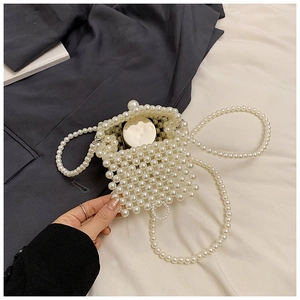 Detailed view of woven pearl mini bag featuring round beads and matching long shoulder strap