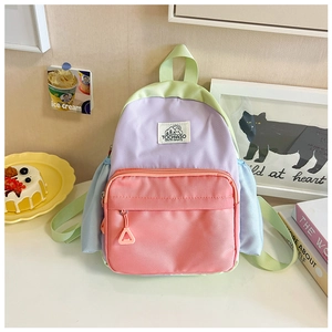 Close-up of color-block children's backpack with nylon fabric and durable front zipper pocket