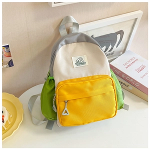 Detail of color-block kids backpack with waterproof nylon fabric and mountain logo patch
