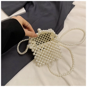 Detail view of woven pearl beads on a mini crossbody bag with long shoulder strap