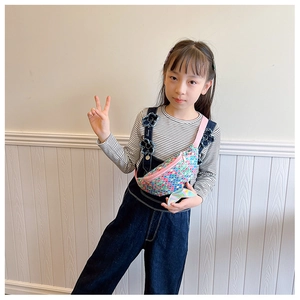 Close-up of kids sequin waist bag featuring colorful scales and a glittery mermaid tail