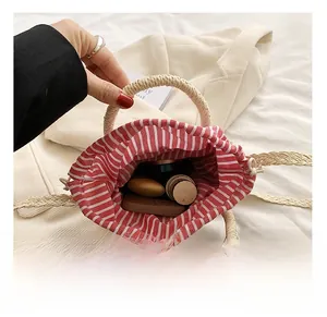 Detail view of woven straw bucket bag showing striped lining and interior capacity