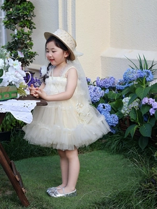 Detail of elegant white tulle dress for girls with tiered mesh and ruffle straps