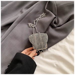 Close-up of mini silver rhinestone crossbody bag with metal chain strap for kids