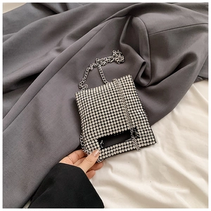 Detail of silver rhinestone mini handbag with sparkling crystals and hollow handle