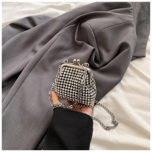 Close-up of a sparkling rhinestone mini evening bag with a vintage silver metal frame