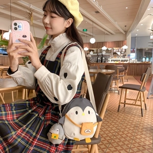 Cute cartoon penguin crossbody bag for kids with 3D details and plush keychain accessory