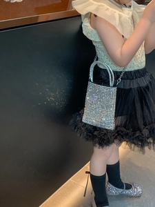 Detail of silver rhinestone kids tote bag with crystal handles and chain strap