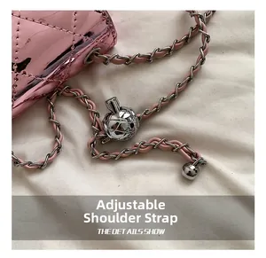 Detail of adjustable metal ball on pink quilted laser finish crossbody bag strap