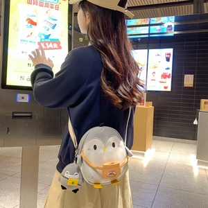 Cute penguin-shaped kids crossbody bag with plush charm and contrast colors