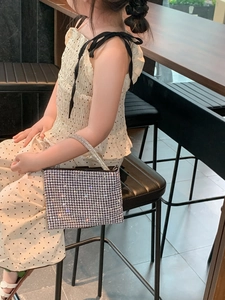Detail showing high-quality silver rhinestones on kids fashion handbag with chain