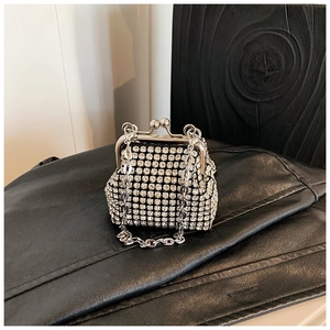Detailed macro of silver rhinestone mesh on a mini evening crossbody bag with metal chain