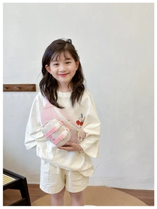 Pink and beige colorblock kids chest bag with adjustable strap worn by a young child