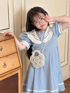 Detail of a handmade white pearl beaded crossbody bag for kids with stylish summer dress