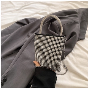 Close-up of sparkling silver rhinestone handbag for girls with sleek metal chain strap