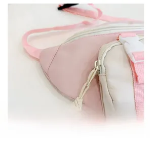 Detailed close-up of smooth zipper with cord pull and buckle on kids pink fanny pack