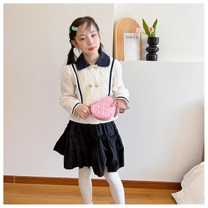 Close-up of pink quilted heart-shaped crossbody bag with gold chain strap for girls