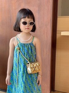 Kids quilted gold crossbody bag paired with pearl jewelry and floral dress style