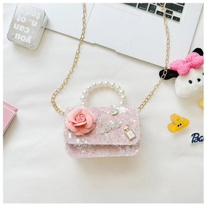 Detail of pink tweed girl's bag with sequins, 3D floral accent and pearl handle