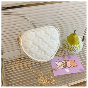 Detail of white heart-shaped crossbody bag with quilted stitching and gold chain
