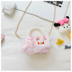 Detailed view of pink lace crossbody bag with pearl handle and sequin girl motifs
