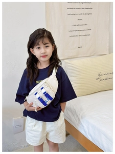 Detail of white canvas kids chest bag featuring blue webbing straps and buckle closure
