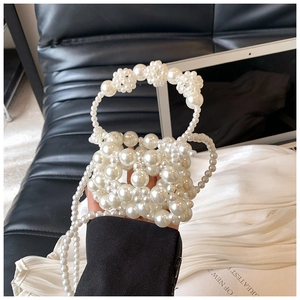 Detail of handmade pearl mini handbag for girls with beaded handle and crossbody chain