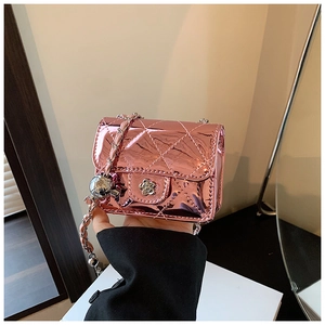 Detail of pink laser leather crossbody bag with chain strap and camellia rotary lock