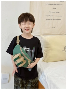 Kid wearing stylish green and khaki color block canvas chest bag with adjustable strap