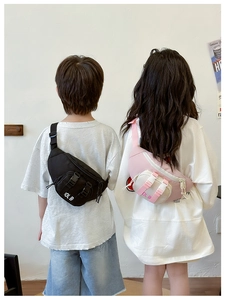 Rear view of children wearing black and pink contrast chest bags with zipper details