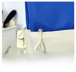 Close-up of smooth zipper with triangle pull on contrast color nylon school bag