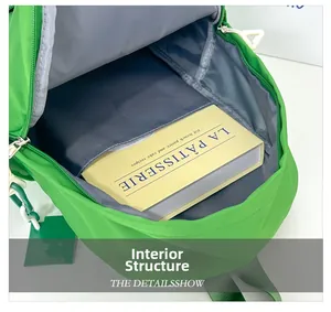 Internal structure of green schoolbag showing large capacity and internal pocket