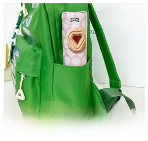 Close-up of side pocket on green nylon kids backpack showing storage capacity