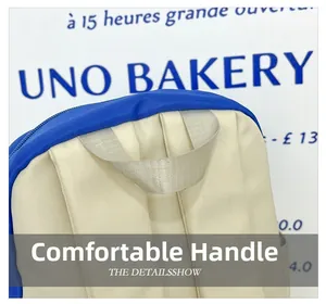 Macro view of the cream nylon kids backpack with reinforced handle and blue zipper