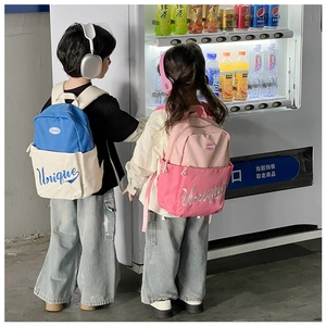 Detail showing blue and pink color-block kids backpacks with unique lettering design