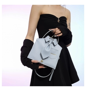 Creative light blue shirt-shaped handbag with tie detail and fashion gold lettering