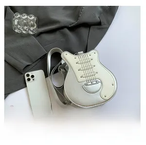Detail showing the guitar-shaped bag with silver metallic finish and rivet string accents