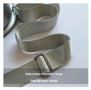 Macro detail of a wide adjustable guitar style shoulder strap with silver buckle