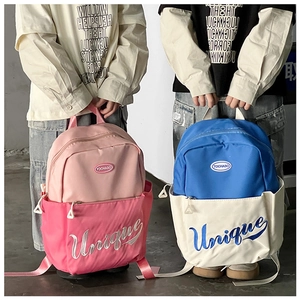 Kids backpack showing pink and blue color-blocking designs with unique embroidered letters