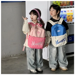 Kids color-block backpack with Unique embroidery shown on models in a daily setting