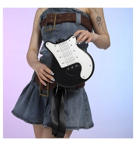 Detail of creative guitar-shaped crossbody bag with rivets and wide nylon shoulder strap