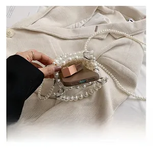 Detail show of pearl beaded crossbody bag capacity for smartphone and lipstick