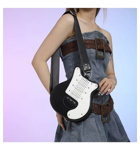 Detailed view of creative black and white guitar-shaped crossbody bag with wide strap