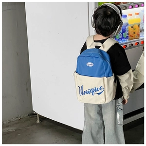 Rear view of a child wearing the blue and white unique letter print school backpack