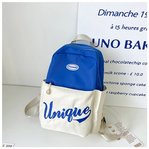 Detail view of Klein blue contrast backpack showing Unique embroidery and front pocket texture