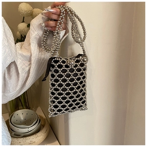 Detail of silver metallic beaded square crossbody bag with black drawstring liner