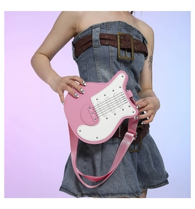 Close-up of pink guitar-shaped crossbody bag with silver hardware and adjustable strap